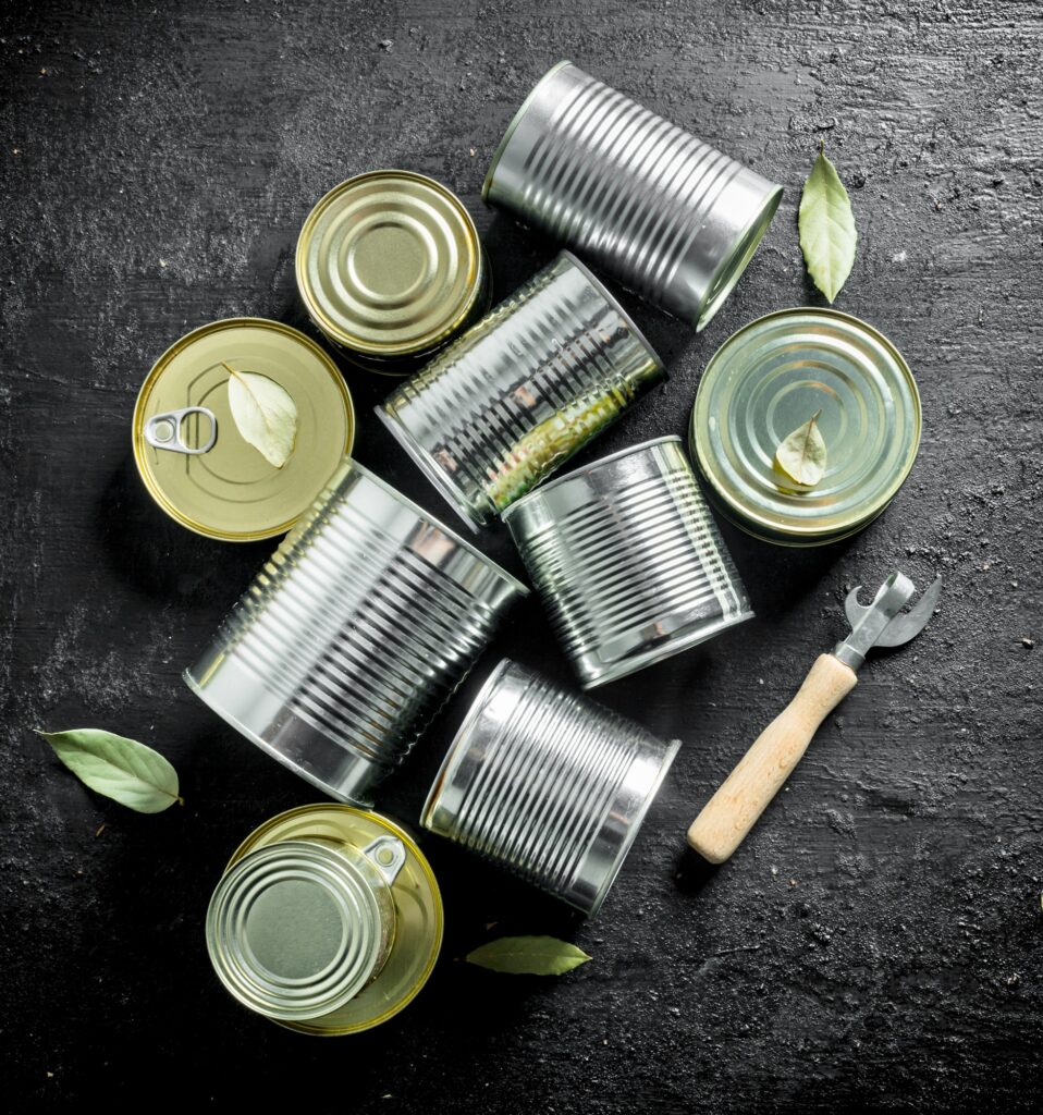 Assortment of different types of tin cans with canned food.